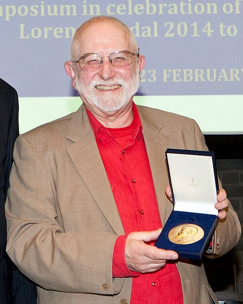 Photograph of Michael Berry holding the Lorentz Medal in its case